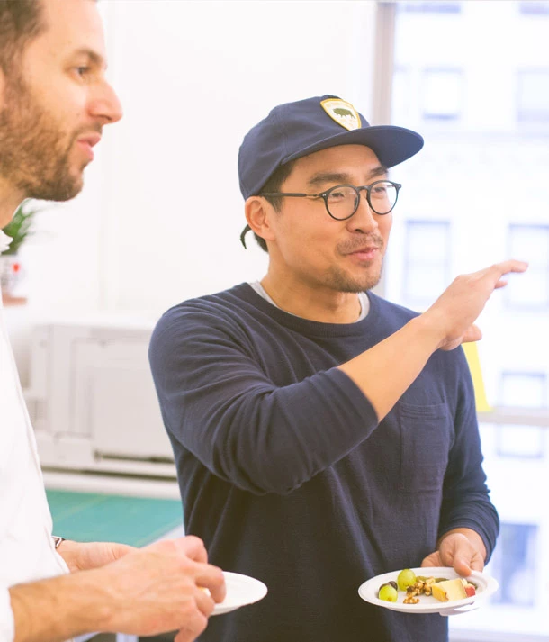 men holding plates talking