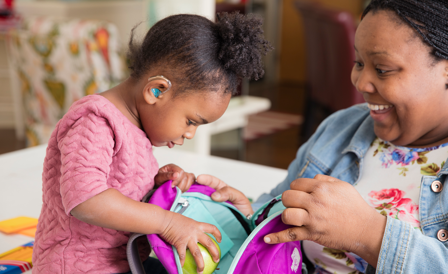 woman with young girl with hearing technology